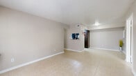 This single-story, 2-bedroom, 2-bathroom home in Houston's 77083 area offers a practical and comfortable layout designed for efficient everyday living. Light-toned tile flooring runs consistently throughout the entire home, creating a cohesive and easy-to-maintain interior.

The open living area provides a generous amount of space and connects naturally to a dedicated dining room. The galley-style kitchen features dark cabinetry with granite-style countertops, a stone tile backsplash, and black appliances including a refrigerator and range. A pass-through window connects the kitchen to the dining and living areas, enhancing the sense of openness.

Both bedrooms are well-proportioned, with the primary bedroom offering a comfortable footprint. Each bedroom includes a ceiling fan with light fixture, a window that brings in natural light and outdoor views, and access to a closet. The neutral-toned walls contribute to a calm, airy ambiance throughout.

The two bathrooms are finished with tile flooring, dark wood vanities topped with granite-style countertops, and white tiled tub-shower combinations. A hallway connects the main living spaces to the bedrooms and bathrooms. The home also includes a dedicated laundry area, adding to its practical appeal.