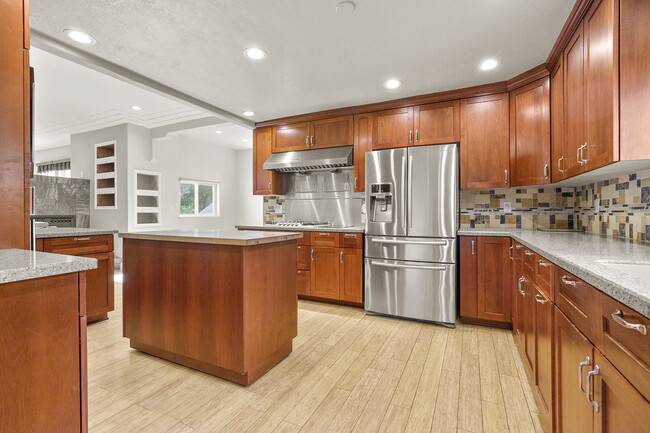 Gorgeous chef's kitchen with a mobile island, stainless steel appliances, and custom cabinets. - 12 N 23rd St