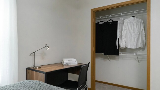 Experience effortless off-campus living with spacious closets with built-in organizers in every bedroom, providing every individual with abundant space for clothes and personal flair. - The Row Apartments