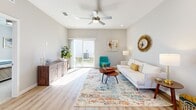 Located at 1201 Cleveland Ave in Wildwood, FL, this well-designed single-story home offers 3 bedrooms, 2 bathrooms, a dedicated office, and a thoughtful open-concept layout. Light-toned luxury vinyl plank flooring flows throughout the main living areas, uniting the kitchen and living room into a bright, cohesive space. The kitchen is a standout feature, showcasing white shaker cabinetry, a subway tile backsplash, granite countertops, stainless steel appliances, and a peninsula island with bar seating, all illuminated by stylish pendant lighting. The living room is generously proportioned, benefiting from a ceiling fan, recessed lighting, and a sliding glass door that opens to the backyard patio and yard. The primary bedroom offers plush carpeting, a ceiling fan, and access to a dedicated closet with built-in wire shelving. A second bedroom mirrors this comfortable style with natural light and soft carpet. The office provides a quiet, carpeted retreat with neutral tones ideal for productivity. The bathrooms are finished with tile surround tub-shower combos and wire shelving storage. Three closets provide ample storage throughout. Outside, a patio overlooks a well-maintained grassy yard, completing this move-in-ready Florida home.