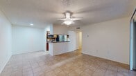 This 610 square foot apartment at Lakewood Place offers a well-designed living space on a single floor. The layout includes one bedroom measuring 130 square feet, one bathroom, a kitchen, a hallway, and a closet. The kitchen is equipped with modern appliances, including a stainless steel refrigerator and stove, and features wooden cabinetry with ample storage space. The bathroom boasts a clean, tiled design with a standard bathtub and shower combination. The bedroom is carpeted and includes a ceiling fan and a large window, providing natural light and ventilation. A spacious closet with wire shelving offers generous storage solutions. The living areas feature a mix of carpeting and what appears to be hardwood or laminate flooring, contributing to a warm and inviting atmosphere. Ceiling fans throughout the apartment help maintain comfortable temperatures. The overall design prioritizes functionality and efficient use of space, making it an ideal choice for individuals or couples seeking a compact yet comfortable living environment.