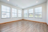 Located at 7710 Terrace Ave in Middleton, WI, this well-appointed three-bedroom, two-bathroom residence offers a thoughtfully designed single-floor layout. The kitchen is a standout feature, boasting rich dark cabinetry, granite countertops, stainless steel appliances, and light hardwood flooring, all brightened by multiple windows with neighborhood views. The open kitchen flows into the living area, which is finished with neutral carpet and warm wood baseboard trim throughout.

The primary bedroom offers generous proportions, plush carpeting, and a closet for storage. The additional bedrooms feature large windows that bring in ample natural light, with hardwood-style flooring providing a clean, modern feel. A dedicated closet with built-in shelving is conveniently located along the hallway.

The two bathrooms are finished with large-format tile flooring and warm maple cabinetry with white countertops. One bathroom features a full walk-in glass-door shower, while the second offers a similarly clean aesthetic. A private balcony accessed from the unit provides outdoor space with open views of the surrounding Middleton neighborhood. The overall design is clean and contemporary, with consistent warm wood trim accents tying the space together throughout.