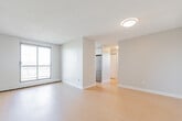 Located at 44 Glen Rd in Hamilton, Ontario, this 2-bedroom unit offers a practical and well-laid-out single-floor plan. Light-toned hardwood flooring runs throughout the space, creating a clean and cohesive aesthetic across all rooms.

The combined kitchen and living area serves as the heart of the unit, featuring a stainless steel refrigerator and an open layout that connects daily living and dining functions. A sliding glass door leads to a private balcony with outdoor views of surrounding greenery, filling the room with natural light.

The primary bedroom is a well-proportioned room featuring a sliding glass door that opens to a balcony, baseboard heating, and ample wall space. The second bedroom is bright and functional, with a large window that draws in natural light and offers views of the neighbourhood. A built-in work surface and white tile backsplash add practical utility to this room. Both bedrooms are finished with the same light hardwood flooring and neutral-toned walls.

A hallway connects the main living areas to the bedrooms and entrance, providing a clear and organized flow throughout the unit. Textured ceilings and baseboard heating are consistent features across the space, contributing to a functional and comfortable environment.