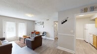 Located at 3528 Gentian Blvd in Columbus, Georgia, this single-story, 2-bedroom, 3-bathroom home offers a practical and comfortable layout across its single floor. Light gray walls, wood-look flooring, and textured ceilings create a consistent, neutral aesthetic throughout the space.

The living room serves as the heart of the home, featuring a set of French doors that invite natural light and provide outdoor access. Adjacent to it, the dedicated dining room is accented with a chair-rail molding detail along the walls, lending a subtle architectural touch.

The galley-style kitchen is equipped with warm honey-toned wood cabinetry, granite-look countertops, and white appliances including a refrigerator and dishwasher, with direct access to a utility area.

The primary bedroom offers a walk-in closet and connects to one of the three bathrooms. The second bedroom includes a ceiling fan, multiple windows for natural light, and ample floor space. Each bathroom features wood vanities with granite-look countertops, large mirrors, and wood-look flooring.

Additional highlights include a dedicated laundry area, a hallway connecting the main rooms efficiently, and three closets distributed throughout the home for generous storage. The overall design is clean, functional, and move-in ready.