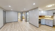 Located at 17 Regan St in Vernon Rockville, CT, this two-bedroom, one-bathroom unit offers a well-designed single-floor layout with a clean, modern aesthetic. Light-toned hardwood flooring flows consistently throughout every room, lending a bright and cohesive feel to the entire space.

The open-concept kitchen and living area serves as the heart of the unit. The kitchen is outfitted with gray-blue cabinetry, granite countertops, a stainless steel range, and a warm mosaic tile backsplash that adds a distinctive visual accent. The layout allows for seamless interaction between cooking and living spaces, making it functional for everyday use.

Both bedrooms are comfortably proportioned with light-filled windows offering views of surrounding trees, baseboard heating, and easy closet access — one bedroom features a dedicated closet with built-in shelving. The rooms are finished in neutral tones, providing a versatile backdrop for various furnishing styles.

The bathroom is neatly appointed with a white vanity, tiled flooring, and a tub-shower combination, maintaining the clean and updated character found throughout the unit.

Recessed lighting in the main living area and consistent gray door trim and baseboards tie the design together, giving the space a polished, move-in-ready appearance.