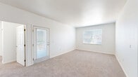 Located at 15255 E 40th Ave in Denver, Colorado, this two-bedroom, one-bathroom residence offers a functional and well-organized single-floor layout. The open entry area flows into a carpeted living room bathed in natural light from large windows and a glass-panel door that leads to a private outdoor access point, providing a bright and airy atmosphere throughout.

The galley-style kitchen features warm wood cabinetry, wood-look vinyl flooring, a full suite of white appliances including a refrigerator, electric range, and dishwasher, along with a stainless steel sink and a breakfast bar that connects to the main living area.

Both bedrooms are carpeted and offer a comfortable sense of space. The primary bedroom includes a closet with built-in shelving and an additional door providing flexible access. The second bedroom also features a closet with a rod and shelf, along with a window that lets in natural light. Each room is finished with clean white walls and neutral tones throughout.

The bathroom is equipped with a full tub-and-shower combination, white subway-style wall tile, and stainless steel grab bars for added accessibility. Clean, minimal finishes keep the space feeling fresh and functional. This residence offers a practical and comfortable layout well-suited for Denver living.