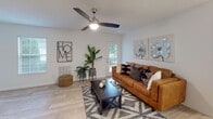 Located at 771 E Butler Rd in Mauldin, South Carolina, this single-floor residence offers a well-designed layout with a clean, modern aesthetic throughout. Light wood-look flooring flows through the main living areas, creating a cohesive and airy feel.

The galley-style kitchen is a standout feature, outfitted with crisp white cabinetry with matte black hardware, white countertops, a stainless steel sink, and stainless steel appliances including a refrigerator, electric range, microwave, and dishwasher. The kitchen connects seamlessly to the rest of the home, offering practical functionality.

The living room is bright and welcoming, featuring a ceiling fan, light-toned walls, and a glass-paned door that opens to an outdoor patio, allowing natural light to pour in. Adjacent to the living room, the dedicated dining area features recessed lighting and classic chair-rail molding, providing a defined space for meals.

The unit includes two bedrooms, each with carpet flooring and ceiling fans. The primary bedroom benefits from a window with outdoor views. Two bathrooms feature wood-look flooring, curved shower rods with tub/shower combinations, and clean white finishes.

A dedicated in-unit laundry area with a full-size washer and dryer and overhead shelving adds everyday convenience to this well-appointed Mauldin residence.