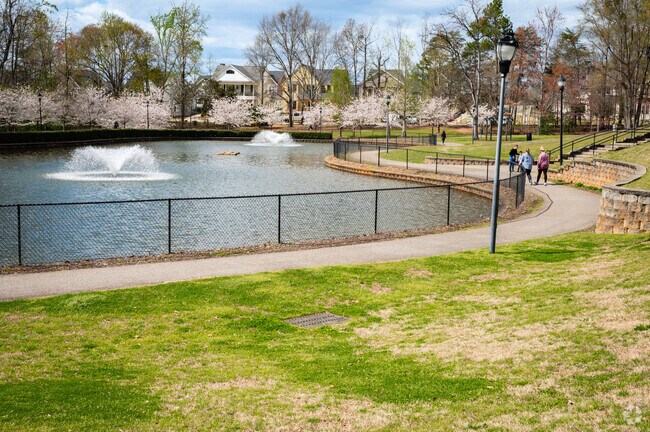 Residents of Pleasantburg enjoy the walking path around the fountains at Legacy Park.