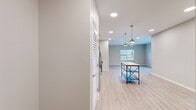 Located at 1112 S Grant Ave in Springfield, Missouri, this well-appointed two-bedroom, two-bathroom single-story home offers a thoughtfully designed layout with modern finishes throughout. Light-toned luxury vinyl plank flooring flows seamlessly across the entire home, lending a clean and cohesive aesthetic to every room.

The open-concept kitchen and living area serves as the heart of the home. The kitchen is outfitted with crisp white shaker cabinets, granite-look countertops, a subway tile backsplash, and a full suite of stainless steel appliances, including a French door refrigerator, microwave, range, and dishwasher. Stylish pendant lighting illuminates the space, while recessed lighting adds to the bright, welcoming atmosphere.

The primary bedroom is a generously sized retreat featuring a ceiling fan and natural light from a window overlooking the outdoors. French doors in another room open to the exterior, providing a seamless indoor-outdoor connection. Both bedrooms include dedicated closets with wire shelving for organized storage.

The bathrooms are finished with clean, neutral tones, each featuring a tub-shower combination. Additional conveniences include an in-unit laundry area and a utility room. The home's neutral color palette and modern design details make it a versatile and move-in ready space.