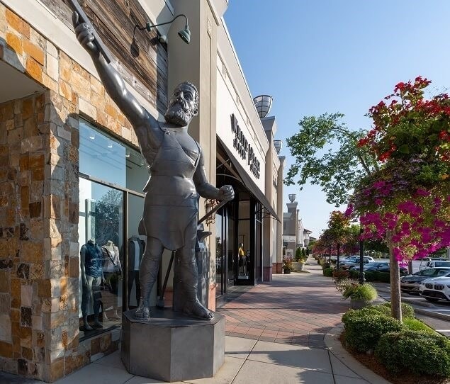 Wide sidewalks lead past several shops