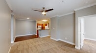 This well-appointed Baton Rouge residence offers three bedrooms and two bathrooms across a single floor, thoughtfully designed for comfortable everyday living. The open-concept living and dining area is finished with plush neutral carpeting, crown molding, and a ceiling fan with light, creating a warm and inviting atmosphere. French doors in the primary bedroom flood the space with natural light and provide outdoor access, while a ceiling fan adds comfort. The remaining bedrooms also feature carpeting, ceiling fans, and windows that invite natural light.

The galley-style kitchen is outfitted with warm wood cabinetry, granite-look countertops, a full suite of white appliances including a refrigerator, electric range, microwave, and dishwasher, and durable hardwood-style flooring. A peninsula counter opens toward the living area, enhancing the sense of connectivity. Crown molding adds a refined touch throughout the kitchen.

The bathrooms feature white vanities with ample counter space, large mirrors, and hardwood-style flooring. A utility room provides added convenience for household needs. Throughout the home, neutral gray walls, white trim, and consistent flooring choices create a cohesive and clean aesthetic well-suited for a variety of lifestyles.