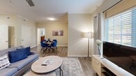Located at 100 Enterprise Way in Maryville, TN, this well-appointed one-bedroom, one-bathroom unit offers a thoughtfully designed single-floor layout. Hardwood-style flooring runs throughout, complemented by neutral warm-beige walls and clean white trim that lend a cohesive, modern aesthetic.

The open-concept living and dining area is bright and welcoming, featuring crown molding, a ceiling fan, and large windows with transom accents that invite generous natural light. The kitchen is efficiently designed with dark espresso cabinetry, granite-style countertops, a peninsula with pendant lighting, and black appliances including a full-size refrigerator and range.

The bedroom is a comfortable retreat, highlighted by French doors with transom windows providing outdoor views, a ceiling fan, and direct access to a spacious walk-in closet outfitted with multi-tier wire shelving and hanging rods. The full bathroom features a dark-vanity with granite countertop and a tub-shower combination.

A dedicated laundry area houses a full-size side-by-side washer and dryer with overhead shelving, adding everyday convenience to this functional and well-finished Maryville residence.