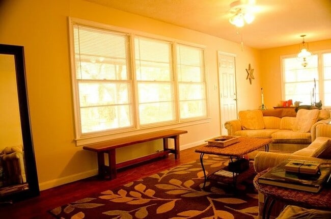 Living room with large windows overlooking the back yard - 5087 Pittman St
