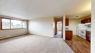 Located at 600 Minnesota Ave in Big Lake, MN, this two-bedroom, one-bathroom unit offers a practical and comfortable single-floor layout. The spacious living room features soft neutral carpet, textured ceilings, a wall-mounted air conditioning unit, and a large window that brings in natural light and outdoor views. Baseboard heating runs throughout the unit, ensuring consistent warmth.

The kitchen is well-equipped with warm-toned wood cabinetry, granite-look countertops, a double sink, a hardwood-style vinyl floor, and white appliances including an electric range and refrigerator. A track lighting fixture adds functional illumination to the cooking space. The kitchen flows naturally into the living area, creating an open and connected feel.

Both bedrooms are carpeted and feature sliding wood-panel closet doors, providing ample storage. The primary bedroom is generously sized, while the second bedroom includes a window with natural light and baseboard heating. Warm wood trim details accent the doors and windows throughout.

The bathroom is clean and functional, featuring tile flooring, a wood-tone vanity with a white countertop, a full tub/shower combination with grab bars, and a textured wall finish. The overall aesthetic of the unit is neutral and move-in ready, offering a straightforward and comfortable living environment.
