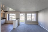 Located at 8522 C Ave in Hesperia, California, this single-story home offers a practical and well-organized layout designed for comfortable everyday living. The open-concept floor plan seamlessly connects the living area to the kitchen, creating a bright and functional shared space. Large windows throughout the home invite abundant natural light and offer views of the surrounding Hesperia landscape.

The kitchen is well-appointed with white cabinetry offering generous storage, dark granite-style countertops, a gas range, dishwasher, and a built-in sink. A peninsula counter serves as a natural divider between the kitchen and the living area, enhancing the open feel while providing additional workspace. A ceiling fan with a light fixture keeps the kitchen and adjacent living space comfortable.

The living room is generously sized, featuring neutral carpet, a textured ceiling, and large windows that frame outdoor views. The bedrooms continue the carpeted flooring and neutral color palette, each offering ample wall space and natural light through sizable windows. The bathroom features light wood-style flooring, a clean white bathtub, and a high horizontal window that allows natural light while maintaining privacy. Throughout the home, the design is clean, neutral, and move-in ready.