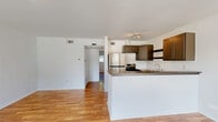 This 550-square-foot, single-story apartment offers a thoughtfully designed living space in Houston, TX. The property features one bedroom, measuring 190 square feet, and one bathroom. The open-concept layout combines the kitchen and living room, creating a spacious feel despite the compact footprint. 

The apartment boasts modern finishes throughout, with gleaming hardwood floors that extend from the entryway to the bedroom. The kitchen is equipped with contemporary taupe cabinetry, stainless steel appliances, and a functional breakfast bar that doubles as additional counter space. A pendant light fixture adds a touch of style over the dining area.

Large windows in the living area and bedroom flood the space with natural light, while offering views of the surrounding landscape. The bathroom features a clean, white design with a shower/tub combination. Two closets provide ample storage space.

A ceiling fan in the bedroom helps maintain comfort, and the neutral color palette throughout allows for easy personalization. The property's layout, as seen in the 3D floor plan, demonstrates an efficient use of space, making this apartment an ideal choice for those seeking a cozy yet modern living environment in the heart of Houston.