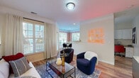 Located at 150 Coveside Lane in Chesapeake, Virginia, this single-floor, 3-bedroom, 2-bathroom home offers a thoughtfully organized layout with a welcoming entryway featuring built-in coat hooks and a bench. The open living area is finished with warm wood-style flooring, crown molding, and large windows that fill the space with natural light. The combined living and dining area flows seamlessly, with the dining nook enclosed by a striking bay window arrangement framed by bold patterned wallpaper, offering pleasant outdoor views. The kitchen features white cabinetry, granite-style countertops, stainless steel appliances, and a window above the sink for added natural light. The primary bedroom is generously sized, carpeted for comfort, and includes a ceiling fan and a large window with outdoor views. The additional bedrooms are well-proportioned and versatile. Two full bathrooms serve the home, including one with a tub-shower combination and wood-style flooring. Throughout the home, details such as crown molding in the living areas, consistent flooring materials, and abundant window placement contribute to a bright and cohesive living environment.