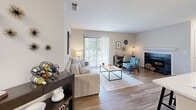 Located at 5802 Tattersall Dr in Durham, NC, this single-story, one-bedroom, one-bathroom residence offers a thoughtfully arranged floor plan that maximizes its compact footprint. Wood-style flooring flows throughout the main living areas, lending warmth and visual continuity to the space.

The open-concept living, dining, and kitchen area forms the heart of the home. The living room is bright and inviting, anchored by a fireplace and a large sliding glass door that fills the space with natural light and provides outdoor access. A defined dining nook with chair-rail detailing sits adjacent to the living area, offering an intimate setting for meals.

The kitchen is efficiently designed with white cabinetry, a light countertop with an integrated sink, and stainless steel appliances including a refrigerator and range. A pass-through counter connects the kitchen to the dining and living areas, enhancing the open feel.

The bedroom is a comfortable, well-proportioned retreat featuring wood-style flooring, a window with outdoor views, and a textured ceiling. A dedicated closet provides storage. The bathroom includes a full tub-and-shower combination with tile surround and a curtain enclosure, finished in a clean, neutral palette.