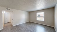 Located at 633 W Vandament Ave in Yukon, Oklahoma, this single-story, 2-bedroom, 1-bathroom home offers a practical and comfortable layout. The living and dining areas feature light-toned luxury vinyl plank flooring that flows seamlessly throughout the common spaces, creating a clean and cohesive look. Textured ceilings are found throughout the home, adding a classic architectural touch.

The kitchen is well-equipped with stainless steel appliances, including a refrigerator, range, and microwave. Two-tone cabinetry with gray lower cabinets and white uppers is complemented by granite-look countertops and a white subway tile backsplash, giving the space a modern, updated feel. Light wood-tone LVP flooring continues here, keeping the space bright and easy to maintain.

Both bedrooms are carpeted for comfort and feature neutral walls, natural light from windows with views of the surrounding neighborhood, and ceiling fans in the primary bedroom to aid in climate control. The spacious primary bedroom offers generous room for furnishings. Two closets provide ample storage throughout the home.

The bathroom includes a tub/shower combination with a curved curtain rod, LVP flooring, and clean, simple finishes. With two dedicated closets and a well-organized floor plan, this home delivers efficient, comfortable living in a convenient Yukon location.