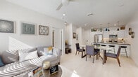 This thoughtfully designed 2-bedroom, 2-bathroom single-floor residence at 5 Ledge Dr. in Schenectady, NY offers a bright and modern living experience. The open-concept layout seamlessly connects the living room, dining area, and kitchen, all finished with light hardwood-style flooring and crisp white walls that maximize the sense of space and natural light. Large windows throughout flood the interior with sunlight, creating a warm and airy ambiance.

The contemporary kitchen is appointed with white shaker cabinetry extending to the ceiling, stainless steel appliances including a French door refrigerator and microwave, dark granite countertops, and a breakfast bar with seating. The living room offers generous natural light through oversized windows, while the adjacent dining area provides comfortable space for a full dining set.

The primary bedroom is a well-proportioned retreat featuring multiple windows with outdoor views and plush carpeting. The second bedroom, also carpeted and naturally lit, offers flexibility as a guest room or home office. Both bathrooms are clean and functional, with the second featuring a tub-shower combination. Additional highlights include four closets for ample storage and a dedicated in-unit laundry area. The overall aesthetic is modern, clean, and move-in ready.