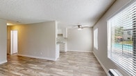 Located at 553 S Magnolia Ave in El Cajon, California, this 2-bedroom, single-floor unit offers a clean and functional layout designed for comfortable everyday living. The living room is bright and welcoming, featuring wood-look plank flooring, neutral warm-toned walls, a textured ceiling, and a ceiling fan with light fixture. Large windows fitted with horizontal blinds allow generous natural light to fill the space, with views of greenery outside. A wall-mounted A/C unit provides climate control, and a front entry door connects directly to the living area.

The galley-style kitchen is well-appointed with crisp white upper and lower cabinetry, light countertops, a stainless single-basin sink, and a white electric range alongside a black refrigerator. A flush-mount ceiling light brightens the workspace, and the same wood-look flooring continues throughout.

Both bedrooms continue the cohesive design with matching flooring, neutral walls, ceiling fans, and windows that bring in natural light. The primary bedroom includes a spacious sliding-door closet with built-in shelving and hanging rods, offering practical storage. The second bedroom also features a window with outdoor views. Clean white baseboards trim every room, contributing to the overall fresh and move-in-ready feel of this well-maintained unit.