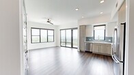 Located at 1777 Peachtree St NE in Atlanta, GA, this modern 2-bedroom, 2-bathroom residence offers a well-designed open-concept layout with clean lines and contemporary finishes throughout. A welcoming entryway with recessed lighting leads into the bright, open living and kitchen area, where large floor-to-ceiling windows and sliding glass doors flood the space with natural light and frame impressive views of the Atlanta skyline and surrounding treetops. The kitchen is outfitted with a full suite of stainless steel appliances, high-gloss white upper cabinets, warm wood-tone lower cabinets, a blue-gray subway tile backsplash, and white quartz countertops — all complemented by rich hardwood flooring. A ceiling fan adds comfort to both the living area and primary bedroom. The primary bedroom features a sliding glass door to a private balcony, wide-format windows with panoramic views, and light hardwood flooring. Each bedroom includes its own dedicated walk-in closet with wire shelving and plush carpet. The bedrooms are carpeted for added comfort. Both bathrooms are finished with wood-tone vanities, white quartz counters, brushed nickel fixtures, and clean tile flooring. The second bathroom includes a soaking tub and shower combination.
