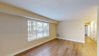 Located at 4809 Columbia Rd in North Olmsted, Ohio, this 2-bedroom, 1-bathroom unit offers a well-organized single-floor layout designed for comfortable everyday living. Warm hardwood-style flooring runs throughout the space, creating a cohesive and inviting atmosphere from room to room.

The living room is bright and open, featuring a large window with blinds that allows natural light to fill the space and offers views of the surrounding neighborhood. The adjacent dining room provides a dedicated area for meals, while the layout flows naturally into the updated kitchen.

The kitchen is a standout feature, showcasing crisp white shaker-style cabinetry, stone-look countertops, recessed lighting, and a full suite of stainless steel appliances including a gas range, dishwasher, built-in microwave, and refrigerator. A pantry provides additional storage beyond the generous cabinet space.

Both bedrooms are well-proportioned with neutral-toned walls and windows that bring in natural light. The primary bedroom offers a comfortable footprint with easy access to closets. Three closets are distributed throughout the unit, offering excellent storage capacity.

The bathroom is clean and modern, featuring a tiled tub/shower combo, a white vanity with stone-look countertops, and wood-look flooring. A hallway connects the main living areas to the bedrooms and bathroom, completing this functional and well-appointed layout.