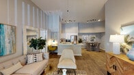 Located in Gainesville, FL, this single-floor residence showcases a thoughtfully designed open-concept layout that seamlessly connects the living, dining, and kitchen areas. Soaring vaulted ceilings with striking vertical striped wall detailing create a dramatic sense of height and openness throughout the main living space. Rich wood-style flooring flows across the common areas, complemented by track lighting and a ceiling fan that enhance both functionality and style.

The kitchen is a standout feature, outfitted with white shaker cabinetry, light quartz countertops, a subway tile backsplash, stainless steel appliances — including a refrigerator, range, and microwave — and a center island with a sink. Adjacent to the kitchen, a dedicated dining area provides an ideal space for meals and entertaining.

The living room offers generous proportions, with large windows inviting natural light and access to an outdoor area. The bedrooms are well-sized and carpeted, each with windows that allow ample daylight. The primary bedroom features a comfortable, tranquil atmosphere, while additional bedrooms are equally inviting. The bathrooms are finished with white cabinetry, full tub-shower combinations, wood-style flooring, and walk-in closet access. The overall ambiance of this residence is bright, modern, and welcoming.