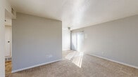 Located at 181 Derrer Rd in Columbus, Ohio, this single-floor, one-bedroom, one-bathroom unit offers a practical and well-organized layout. The living room serves as the central gathering space, featuring wall-to-wall carpet, a ceiling fan, and a sliding glass door dressed with vertical blinds that invites abundant natural light and provides access to the outdoors. A bold red entry door with glass panel accents adds a distinctive touch to the entryway, which is adjacent to a closet offering convenient storage. The kitchen is functionally designed with gray cabinetry, white countertops, a double stainless steel sink with a matte black faucet, and a dishwasher. The bedroom is a comfortable, carpeted room featuring a textured ceiling, neutral gray walls, and a window with blinds that brings in natural light. A hallway connects the main living areas to the bathroom, which includes a full tub and shower combination with white tile surround, a toilet, and a vanity with storage. Stone-look tile flooring in the bathroom adds a grounded, clean aesthetic. Throughout the unit, neutral tones and soft carpet create a cohesive, move-in-ready atmosphere.