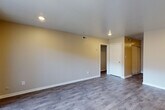 This single-floor residence offers a clean, updated interior with a thoughtful layout that balances living, dining, and private spaces. The open living area is finished with durable wood-look plank flooring and recessed lighting, creating a bright and welcoming atmosphere. A sliding glass door leads to an outdoor patio area, allowing natural light to fill the room and providing easy access to the exterior.

The kitchen is a standout feature, outfitted with crisp white shaker-style cabinetry, gray laminate countertops, and a decorative mosaic tile backsplash in neutral tones. Black appliances — including a gas range, refrigerator, and dishwasher — complement the modern aesthetic, while wood-look flooring ties the space together seamlessly.

The bedrooms offer a quieter, carpeted retreat with neutral wall tones and window treatments that allow for natural light. Closet access is available within the bedroom area, providing practical storage solutions.

The bathrooms are finished in a clean, classic style. One features a full tub-shower combination with white subway tile surround, while a second half bath includes wood-look tile flooring and bright white walls. HVAC vents throughout ensure consistent climate control. Overall, the space presents a functional and modern living environment with updated finishes throughout.