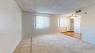 This one-bedroom, one-bathroom unit in Denver, Colorado offers a practical and comfortable single-floor layout. The living room is generously sized, featuring wall-to-wall carpet, neutral-toned walls, a textured ceiling, and dual windows fitted with vertical blinds that allow ample natural light to fill the space. A ceiling fan with lighting adds both comfort and function to the area. The bedroom is a well-proportioned retreat, also finished with soft carpeting and a large window for natural light. A standout feature of the bedroom is the dual mirrored sliding-door closets, providing excellent storage capacity. The kitchen is equipped with white cabinetry, granite-style countertops, a full suite of white appliances including a refrigerator, dishwasher, and stove, and durable hardwood-style flooring. The bathroom features a clean, white tub and shower combination with chrome fixtures. Three closets throughout the unit offer additional storage convenience. With a straightforward layout and functional design details, this unit presents a well-organized living space suited for comfortable everyday living in the Denver area.