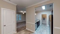 This single-floor residence offers a thoughtfully designed layout that balances comfort and functionality throughout. The open-concept living and dining areas are finished with durable hardwood-style flooring and crown molding, while ceiling fans provide year-round comfort. Natural light filters in through slatted blinds, lending a bright and welcoming ambiance to the main living spaces.

The kitchen is a standout feature, equipped with rich dark cabinetry, granite-look countertops, stainless steel appliances including an over-the-range microwave and electric range, and a pendant light over the sink. Tile flooring and a skylight accent this well-equipped culinary space.

The bedrooms are generously proportioned, each with hardwood-style flooring, neutral-toned walls, and ample natural light. One bedroom features crown molding and a ceiling fan, adding an elevated touch. The bathrooms are finished with tile flooring, granite-top vanities with dark cabinetry, and full soaking tubs with shower combinations, complemented by brushed nickel fixtures and towel bars.

A dedicated laundry area includes wire shelving, washer and dryer hookups, and tile flooring, offering practical utility. Throughout the space, clean lines, neutral tones, and consistent finishes create a cohesive and move-in-ready environment.