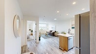 Located at 1800 4th St SW in Calgary's vibrant inner-city community, this 1-bedroom, 1-bathroom unit on the 15th floor offers a thoughtfully designed layout with contemporary finishes throughout. Light wood-tone flooring runs continuously across the space, contributing to a bright and cohesive aesthetic.

The open-concept kitchen is a standout feature, showcasing floor-to-ceiling natural wood cabinetry, a white quartz countertop, and a full suite of stainless steel appliances including a refrigerator, electric range, and built-in microwave. A kitchen island with seating provides a practical and social dining option, while recessed lighting adds to the clean, modern ambiance.

The living room is comfortably proportioned, featuring a large window that frames city views and built-in cabinetry beneath the sill for added storage. The bright, neutral walls and light flooring create an airy feel throughout.

The bedroom accommodates a full-sized bed with ease and includes a generous closet with panel doors and a window that invites natural light and outdoor views. The bathroom is finished with wood-toned cabinetry, a white vanity with an illuminated mirror, and a shower-tub combination with clean, minimal detailing. The overall design is modern, functional, and well-suited for urban living.
