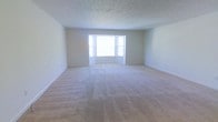 Located at 485 S. Parkview Ave. in Columbus, Ohio, this single-floor property offers a clean and functional layout well-suited for comfortable everyday living. The main living area is notably spacious, providing generous room to arrange furnishings and personalize the space. Plush, neutral-toned wall-to-wall carpeting covers the floor, offering warmth and comfort underfoot while contributing to the room's bright, airy aesthetic. A classic bay window serves as a standout architectural feature, drawing in abundant natural light and creating an inviting focal point along the exterior wall. The bay window's multi-panel design adds a touch of traditional character to the otherwise clean-lined interior. The walls are finished in a crisp, neutral tone that complements the light palette throughout, while a textured ceiling adds subtle visual interest overhead. White baseboards frame the perimeter of the room, lending a polished, well-maintained appearance. The overall ambiance of the space is calm and welcoming, with a neutral color scheme that provides a versatile backdrop for a variety of interior styles. The single-floor layout ensures convenient accessibility throughout, making this property a practical and comfortable option in the Parkview Ave. neighborhood of Columbus, OH.