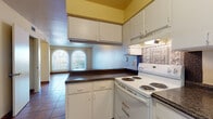 Located at 605 Paredes Line Rd in Brownsville, Texas, this single-floor unit offers a practical and functional layout suited for everyday living. The interior is unified by warm terracotta tile flooring throughout, providing a consistent and easy-to-maintain surface across all rooms.

The living area greets residents with two arched windows that allow natural light to fill the space, complemented by vertical blinds for privacy. The open layout connects seamlessly to the kitchen, which is well-equipped with ample white cabinetry, dark laminate countertops, a coil-burner electric range, a full-size refrigerator, and a built-in sink with additional counter space. The kitchen also features an overhead exhaust hood and generous upper and lower cabinet storage.

The bedrooms are comfortably sized, each outfitted with a ceiling fan and light fixture. One bedroom includes a sliding closet, while another features a walk-in closet with built-in shelving, offering practical storage solutions. Large windows dressed with vertical blinds bring in natural light while maintaining privacy.

The bathroom includes a full soaking tub surrounded by neutral, stone-look tile walls that extend from floor to ceiling, creating a clean and polished appearance. Central HVAC vents are present throughout, ensuring year-round climate control. The overall ambiance of the unit is clean, bright, and move-in ready.