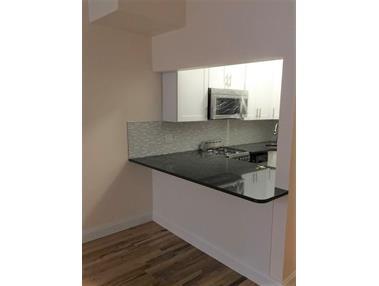 Renovated kitchen overlooking living space - 344 W 52nd St