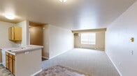 Located at 1632 S Main St in Moscow, Idaho, this 2-bedroom, 2-bathroom apartment offers a practical and comfortable single-floor layout. The open living area features neutral-toned carpet, a wall-mounted A/C unit, baseboard heating, and a window that brings in natural light. The kitchen is efficiently designed with warm wood cabinetry, light countertops, tile flooring, and white appliances including a refrigerator and dishwasher. A dedicated pantry with built-in shelving provides generous storage directly off the kitchen. Both bedrooms are carpeted and finished in soft, neutral tones. The primary bedroom includes a walk-in closet with built-in shelving and hanging rods, while the second bedroom features a window with natural light and baseboard heating. The two bathrooms are well-appointed with wood vanities, light countertops, tile flooring, and a tub-shower combination. A spacious walk-in closet with multi-level shelving and hanging storage adds further functionality to the unit. Throughout the space, warm beige walls and consistent flooring choices create a cohesive, understated aesthetic suited for everyday living.