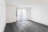 Located at 6736 N Clybourn Ave in Los Angeles, CA, this single-floor unit offers a clean, functional layout with a bright and neutral interior palette. The living area features light gray wood-look laminate flooring and a sliding glass door fitted with vertical blinds, allowing natural light to filter in while providing access to the outdoors. A textured ceiling and a ceiling fan add practical detail to the open common areas.

The kitchen is efficiently designed with white cabinetry extending to the ceiling for ample storage, granite-look countertops, a stainless steel sink, a gas range, a dishwasher, and a full-size refrigerator. Tile flooring in the kitchen and adjacent dining area transitions seamlessly from the wood-look flooring of the living spaces.

The bedroom areas offer a calm, neutral environment, with warm-toned wood-look flooring and clean white walls that provide a versatile backdrop. The full bathroom includes a wide vanity with a single sink, generous cabinet storage below, a large mirror with overhead lighting, and a combined shower and tub enclosed by a curtain, all finished with light tile flooring. The overall ambiance throughout the unit is clean, bright, and move-in ready.