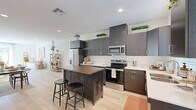 Located at 43738 Buena Vista Way in Lancaster, CA, this single-story, 3-bedroom, 2-bathroom home offers a thoughtfully designed layout with modern finishes throughout. Light wood-style flooring flows through the main living areas, lending warmth and cohesion to the space.

The kitchen is a standout feature, showcasing dark espresso cabinetry that extends to the ceiling, white quartz countertops, stainless steel appliances, and a central island with a butcher block top. Natural light filters in through a window above the sink, brightening the space considerably.

The open living room is bright and inviting, with recessed lighting and a clean, neutral palette that creates an airy ambiance. An adjacent dining area connects the kitchen and living spaces seamlessly.

The primary bedroom is a comfortable retreat, complemented by a generously sized walk-in closet with multi-tiered shelving and hanging rods. Two additional bedrooms offer ample natural light from large windows and share access to a full bathroom featuring a soaking tub and subway tile surround.

A dedicated laundry area and four closets throughout the home provide excellent storage. The attached garage offers additional utility space with an automatic opener. This home combines functional design with clean, contemporary finishes in a practical single-floor plan.