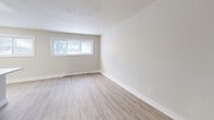 Located at 1050 Highland St in Burlington, Ontario, this thoughtfully updated 2-bedroom, 1-bathroom unit offers a clean, modern aesthetic throughout its well-utilized single-floor layout. The open-concept living area anchors the space, with a contemporary kitchen island featuring a quartz-style countertop, undermount sink, and white cabinetry that flows seamlessly into the dining and living areas. The kitchen is equipped with stainless steel appliances, including a full-size refrigerator, electric range, and built-in microwave, complemented by a white subway tile backsplash. Light wood-look vinyl flooring runs throughout the entire unit, enhancing the bright, cohesive feel. Both bedrooms are well-proportioned, featuring neutral warm-toned walls, windows that bring in natural light with views of mature trees, and baseboard heating. The spacious primary bedroom includes a double-door closet, while the unit also benefits from five closets in total, providing ample storage. The full bathroom is finished with white subway tile in the tub surround, a quartz vanity, modern fixtures, and light stone-look tile flooring. A dedicated entrance and hallway complete the practical, efficient layout of this move-in ready Burlington residence.