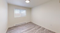 Located at 1590 NE Northwood Dr in Pullman, WA, this single-floor unit offers four bedrooms and two full bathrooms within a well-organized, functional layout. Light-toned luxury vinyl plank flooring runs throughout, lending a clean, cohesive feel to every room. The open-concept living, dining, and kitchen area serves as the heart of the home, with the kitchen featuring white cabinetry, a stainless sink, and overhead lighting. Natural light filters into the bedrooms through blinded windows, and baseboard heating units are present in multiple rooms for efficient climate control. Each bedroom is generously proportioned, with the primary bedroom offering comfortable personal space. Four sliding-door closets — distributed among the bedrooms — provide ample storage. The two bathrooms are finished in neutral tones; one includes a full tub-shower combination, while the other features a vanity with an integrated sink. A dedicated laundry area adds everyday convenience, and a private patio extends the living space outdoors. The unit's bright, neutral palette and consistent flooring create a clean, move-in ready environment suited for a variety of living arrangements.