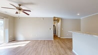 Located at 2315 Zlaten Dr in Longmont, Colorado, this single-floor, three-bedroom, two-bathroom home offers a clean, modern design with consistent light wood flooring and warm neutral tones throughout. The open living area is bright and airy, featuring crown molding, a ceiling fan, and a sliding glass door that leads to a private outdoor patio, filling the space with natural light. A kitchen counter peninsula connects seamlessly to the living room, creating an open-concept flow. The kitchen is well-appointed with white shaker-style cabinetry, granite-style countertops, recessed lighting, and a full suite of stainless steel appliances including a refrigerator, range, microwave, and dishwasher. The spacious primary bedroom includes crown molding, a ceiling fan, a sliding glass patio door, and direct outdoor access. The secondary bedrooms are comfortable in size, each with light wood flooring and ample closet space, including built-in shelving. Both bathrooms feature white vanity cabinetry, granite-style countertops, and wood-look flooring. The full bathroom includes a tub-shower combination. Three hallways connect the layout efficiently, and the overall design presents a cohesive, move-in-ready home with consistent finishes from room to room.