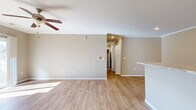Located at 2315 Zlaten Dr in Longmont, Colorado, this single-floor, three-bedroom, two-bathroom home offers a clean, modern design with consistent light wood flooring and warm neutral tones throughout. The open living area is bright and airy, featuring crown molding, a ceiling fan, and a sliding glass door that leads to a private outdoor patio, filling the space with natural light. A kitchen counter peninsula connects seamlessly to the living room, creating an open-concept flow. The kitchen is well-appointed with white shaker-style cabinetry, granite-style countertops, recessed lighting, and a full suite of stainless steel appliances including a refrigerator, range, microwave, and dishwasher. The spacious primary bedroom includes crown molding, a ceiling fan, a sliding glass patio door, and direct outdoor access. The secondary bedrooms are comfortable in size, each with light wood flooring and ample closet space, including built-in shelving. Both bathrooms feature white vanity cabinetry, granite-style countertops, and wood-look flooring. The full bathroom includes a tub-shower combination. Three hallways connect the layout efficiently, and the overall design presents a cohesive, move-in-ready home with consistent finishes from room to room.
