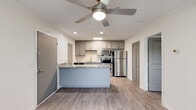 Located at 101 Brixworth Lane in Nashville, TN, this well-appointed one-bedroom, one-bathroom unit offers a thoughtfully designed single-floor layout. The open-concept kitchen is a standout feature, showcasing gray shaker-style cabinetry, a classic white subway tile backsplash, granite countertops, and a full suite of stainless steel appliances including a refrigerator, electric range, microwave, and dishwasher. A peninsula island with additional granite surface space provides extra functionality and doubles as a casual dining or workspace area. Light wood-tone luxury vinyl plank flooring runs throughout the unit, lending a clean, cohesive aesthetic. The living area benefits from a ceiling fan with overhead lighting and flows seamlessly from the kitchen. The bedroom features a tray ceiling with crown molding detail, a ceiling fan, a window allowing natural light, and direct access to the bathroom. The bathroom is finished with granite countertops on the vanity, gray cabinetry, and a full tub-shower combo with large-format tile surround. Additional conveniences include a dedicated closet with louvered doors and an in-unit laundry area, making this a complete and practical living space.