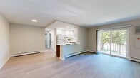 Located at 630 Spruce St in Royersford, PA, this two-bedroom, one-bathroom residence offers a well-organized single-floor layout with a thoughtful mix of updated finishes and functional living spaces. The combined kitchen and living area serves as the heart of the home, where the kitchen stands out with two-tone cabinetry — dark wood lower cabinets paired with crisp white uppers — complemented by white quartz countertops, a classic subway tile backsplash, and light wood-look tile flooring. The living room continues the light flooring and features neutral walls and baseboard heating. Both bedrooms are carpeted in neutral tones, offering a comfortable and quiet retreat. The spacious primary bedroom includes multiple windows that invite natural light and an abundance of closet storage with built-in sliding doors. The second bedroom similarly features a window with outdoor views and baseboard heating. The full bathroom is cleanly finished with large-format tile on both the floors and shower surround, a soaking tub, and a modern white vanity. A private balcony off the unit overlooks a landscaped, tree-lined neighborhood streetscape, providing a pleasant outdoor extension of the living space.