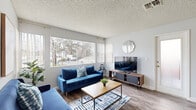 This single-story, 2-bedroom, 1-bathroom residence in Vallejo, California offers a thoughtfully organized layout across a compact yet functional floor plan. Hardwood-style flooring runs throughout the main living areas, lending a cohesive and clean aesthetic to the space.

The living room serves as the central gathering area, highlighted by a large picture window that draws in generous natural light and provides views of the surrounding greenery. A textured ceiling adds architectural character throughout.

The kitchen is designed for efficiency, featuring white cabinetry, stainless steel appliances including a refrigerator and range, and a peninsula with a granite-style countertop that doubles as a breakfast bar with barstool seating. An adjacent dining area with a ceiling fan completes this functional zone.

Both bedrooms are carpeted and equipped with sliding mirrored or panel closet doors, offering practical storage. The primary bedroom provides a comfortable footprint with ample room for furnishings.

The bathroom includes a vanity with a light countertop, a full tub-shower combination, and continued hardwood-style flooring. A hallway connects the private and shared living spaces, maintaining a clear and efficient flow throughout the home.