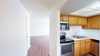 This well-designed 870 square foot apartment offers a harmonious blend of comfort and functionality. The space boasts two bedrooms, including a primary bedroom of 150 square feet, providing ample room for rest and relaxation. The single-floor layout ensures easy accessibility throughout.

The apartment features beautiful wood flooring throughout, creating a warm and inviting atmosphere. The living room is spacious and bright, with large windows allowing natural light to flood the area. A ceiling fan adds both style and comfort to this central living space.

The kitchen is a highlight, featuring modern stainless steel appliances, including a side-by-side refrigerator with water and ice dispenser. Ample wooden cabinetry provides plenty of storage, while the layout ensures efficient meal preparation.

The bathroom is pristine, with a white tiled shower-tub combination that offers versatility for bathing preferences. A closet with built-in shelving provides additional storage solutions, enhancing the apartment's overall organization.

Large windows in the bedrooms ensure they remain light and airy, while closet space in each room offers convenient storage options. The overall neutral color palette throughout the apartment allows for easy personalization to suit individual tastes.

This apartment in Summit West combines modern amenities with a practical layout, creating an ideal living space for those seeking comfort and convenience in a well-maintained environment.
