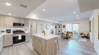 Located at 3050 W 11th St in Los Angeles, this well-appointed single-story residence offers 2 bedrooms, 2 bathrooms, a dedicated office, and a thoughtfully designed open-concept layout. Light wood-tone flooring flows throughout, complementing a neutral, modern palette.

The kitchen is a standout feature, showcasing light wood cabinetry, white quartz countertops, stainless steel appliances including a gas range and French door refrigerator, and a spacious center island with bar seating — ideal for casual dining or entertaining. The kitchen opens seamlessly into the living room, which is bathed in natural light from a large sliding glass door leading to a private balcony with city views. A stacked in-unit washer and dryer is conveniently tucked into the living area.

The generously sized primary bedroom offers a calm, minimalist retreat with recessed lighting. The second bedroom provides flexibility for guests or family. A dedicated office space, complete with a closet, offers a quiet and functional work-from-home environment.

Both bathrooms are well-finished; one features a glass-enclosed corner shower, wood-tone vanity, and white quartz countertops. A walk-in closet provides additional storage. Recessed lighting throughout enhances the bright, clean aesthetic of the entire residence.
