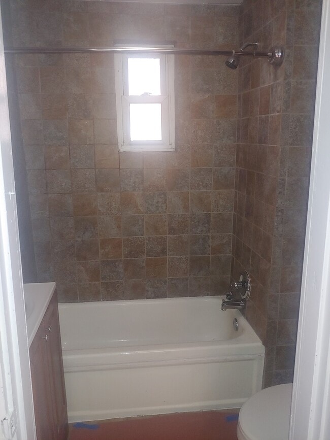 Remodeled shower with curved rod - 310 Fairbanks Ave