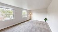 Located at 902 Valley Rd in Elkins Park, PA, this one-bedroom, one-bathroom residence offers a well-organized single-floor layout designed for comfortable everyday living. The space flows from a central hallway — complete with an electrical panel access point and plush carpeted flooring — into each of the principal rooms. The living room is a bright, open area featuring wall-to-wall carpet, neutral painted walls, and multiple windows that draw in natural light and provide views of the surrounding neighborhood. The spacious bedroom continues the carpeted aesthetic, offering a quiet and comfortable retreat with its own window and a dedicated closet for storage. The kitchen is efficiently designed with white cabinetry, dark granite-style countertops, a dark tile backsplash, and durable hardwood-style flooring. White appliances including a refrigerator and range are included, making the kitchen fully functional. A separate area with hardwood-style flooring offers additional versatile space. The bathroom features clean white tile surrounding a full soaking tub, complemented by a window that brings in natural light. Throughout the residence, clean white trim and neutral tones create a bright, cohesive atmosphere.